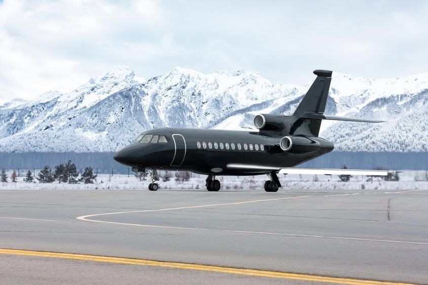 A private jet is seen parked on the runway.