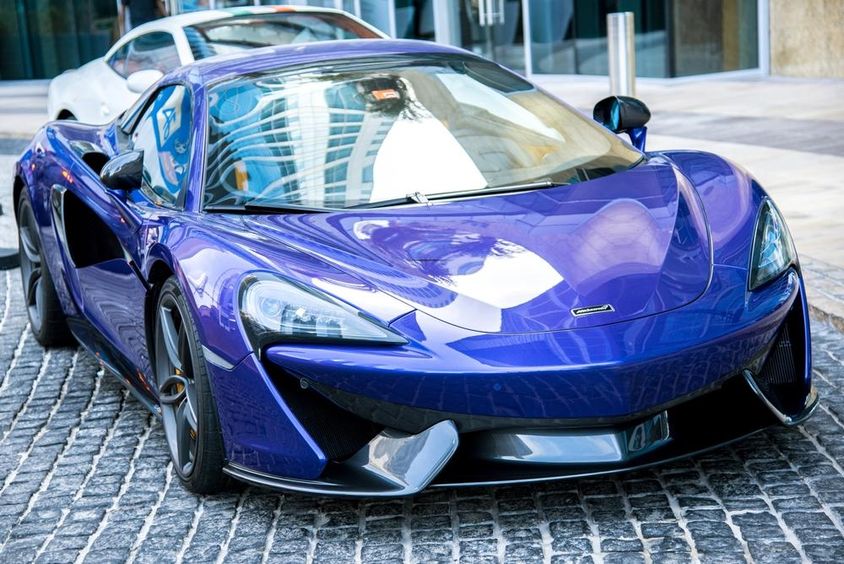 Kék McLaren autó parkol egy Dubai utcán. 