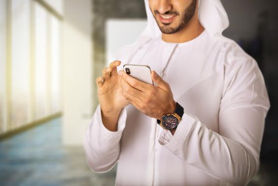 Arab férfi telefonozik. 