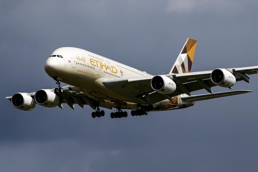 Etihad Airways passenger aircraft flying in the air.