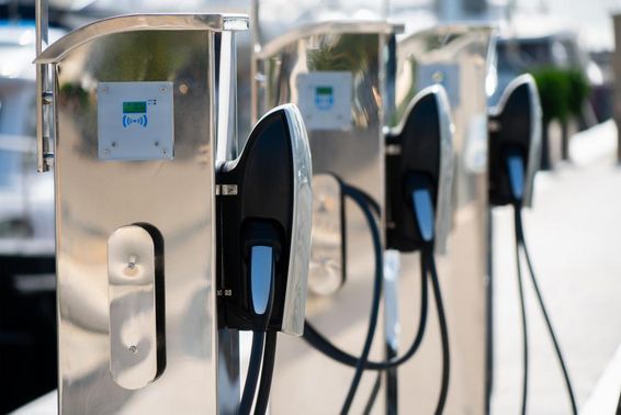Electric car charging station at a luxury marina by the sea.