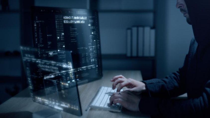 Cyber hacker using advanced algorithms to breach cybersecurity systems.