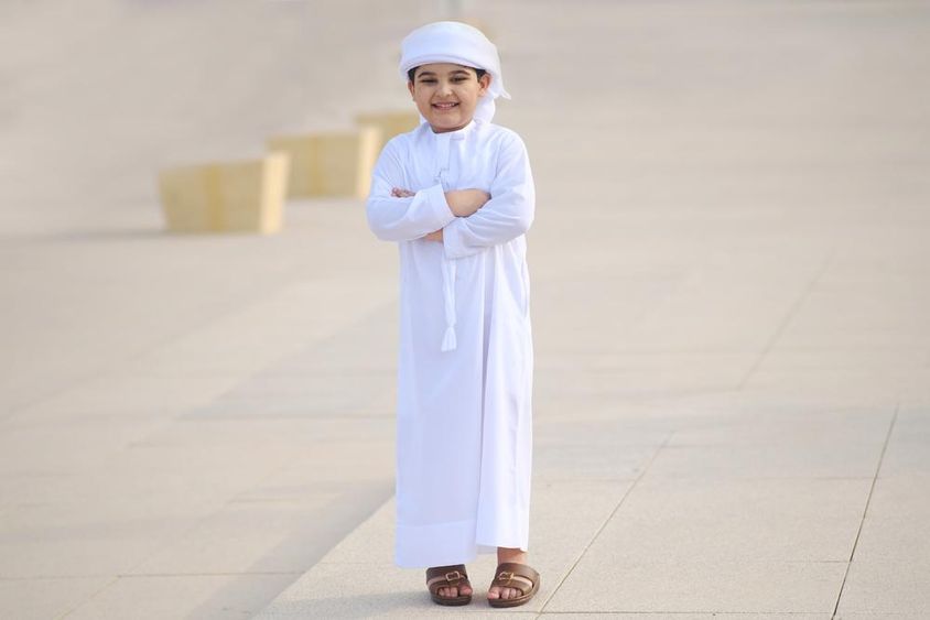 Young Arab student smiling on the way to school.