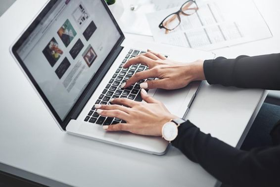 Woman working remotely from home using a laptop.