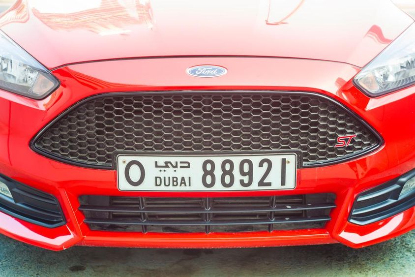Front of modern sports car with Dubai license plate.