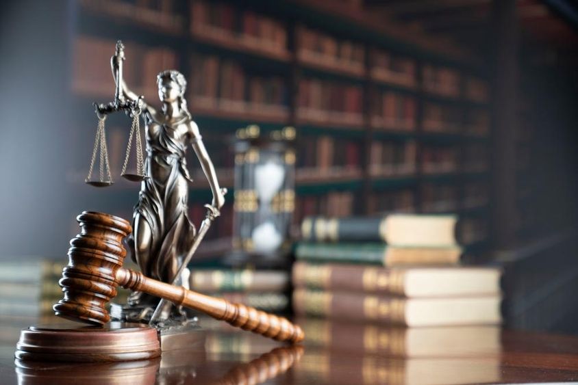 Law symbols with a library background.