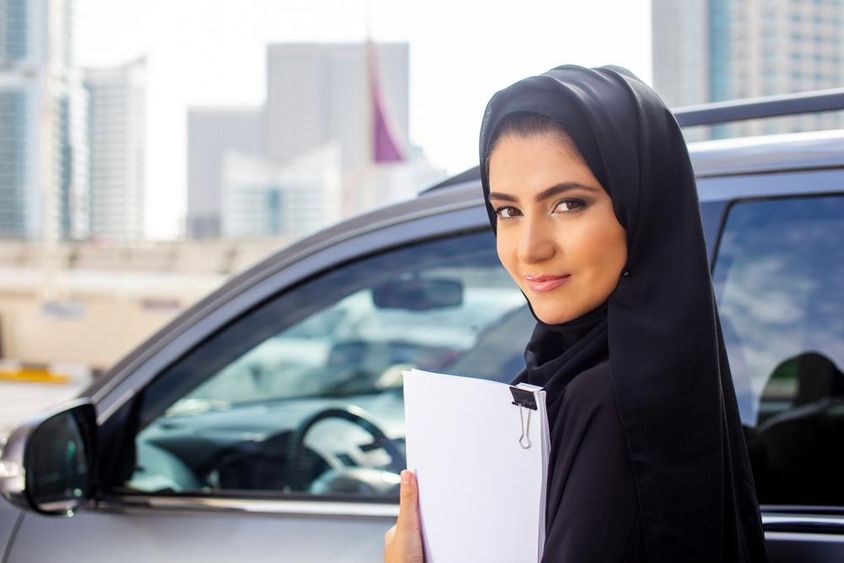 Arab student girl driving her car.