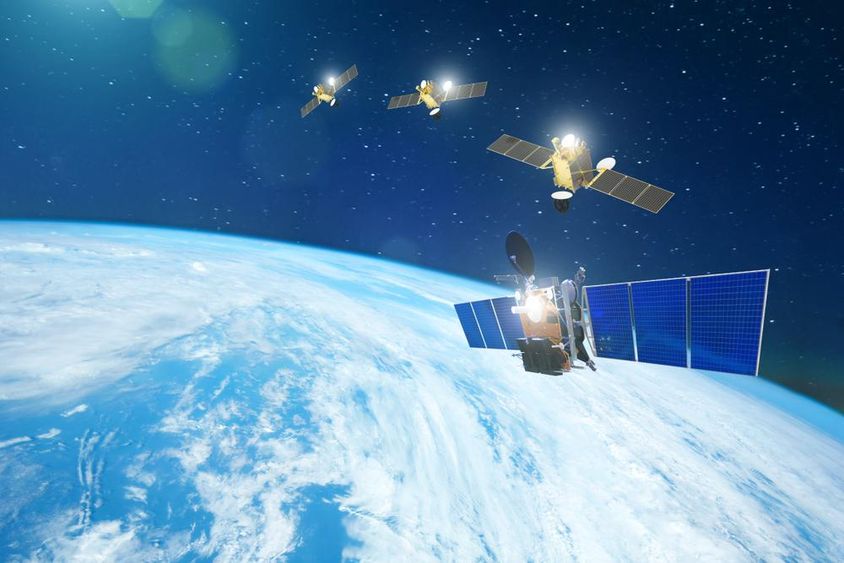 Set of satellites orbiting Earth in a line.