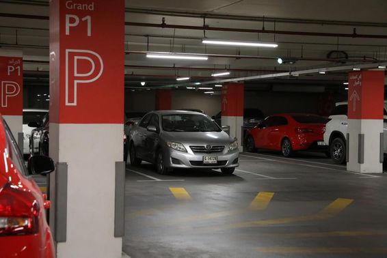 Modern underground parking garage in Dubai with various cars.
