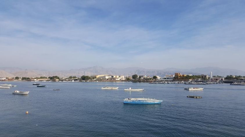 Ras Al Khaimah Bay with blue sea and cloudy sky.