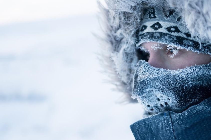 A man in winter clothing and mask.