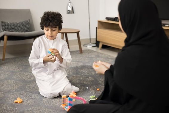 Fiatal arab nő kreatív játékokkal tanít egy muszlim otthonban.