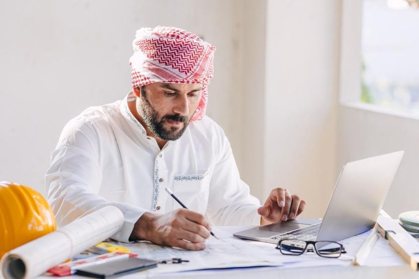 Arab civil engineer working with a blueprint.