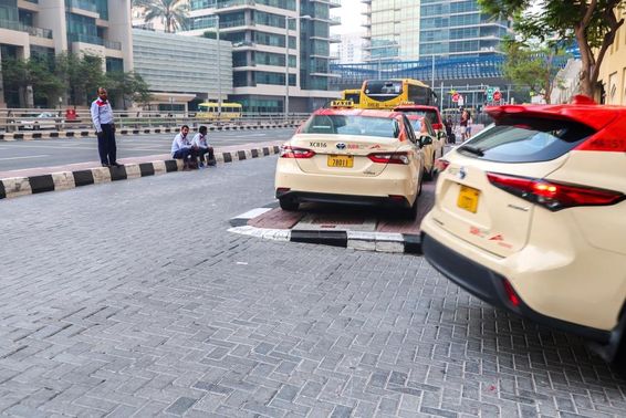 Taxisok egy csoportja várja az utasokat egy dubaji szálloda előtt.
