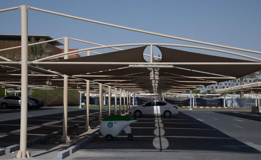 Fabric covers above parking spaces.