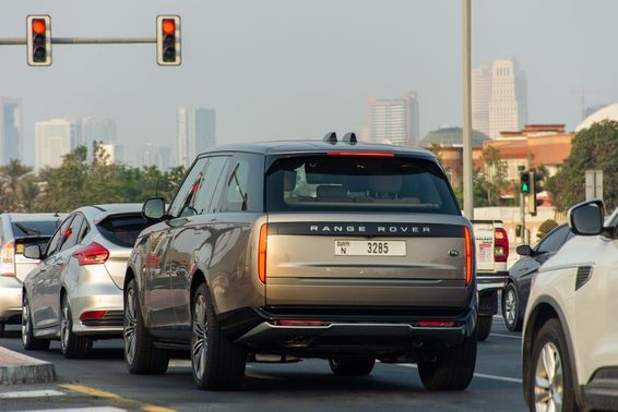 Autók álltak meg egy piros lámpánál Dubai Cityben.