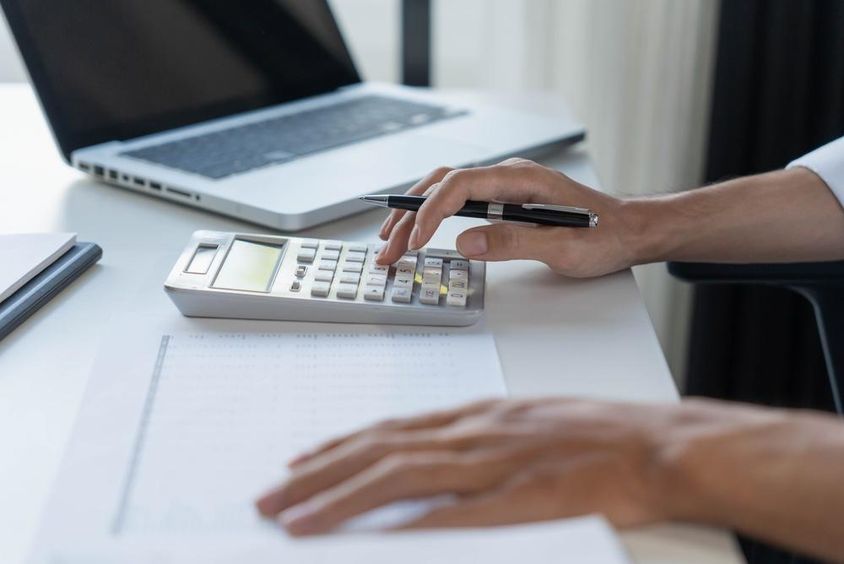 Accountant calculating on a calculator.