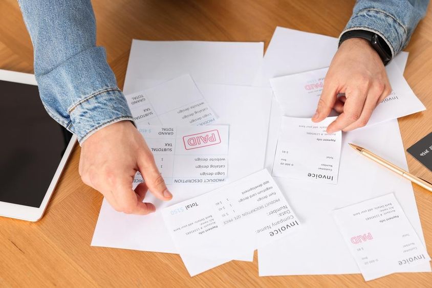 Man organizing various invoices