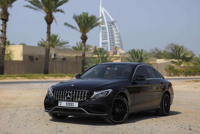 Mercedes Benz C300 parked outdoors in the city of Dubai.