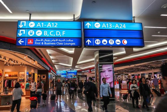 Passengers walking towards departure gates at Dubai International Airport